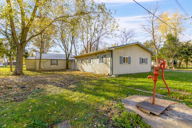 view of side of home featuring a yard