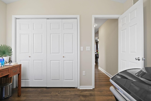 bedroom featuring lofted ceiling, dark wood-type flooring, and a closet