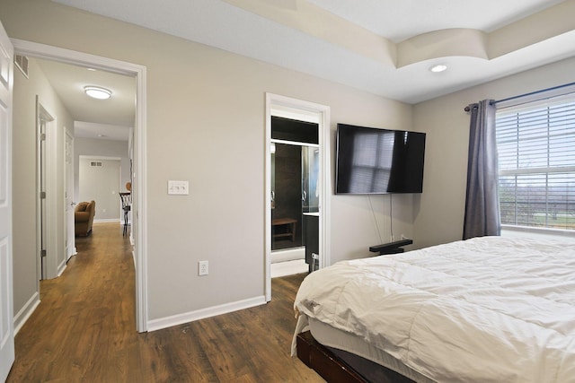 bedroom with dark hardwood / wood-style flooring