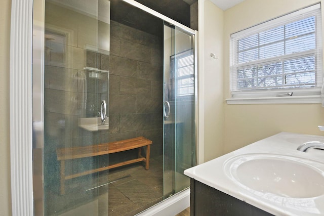 bathroom with walk in shower and vanity