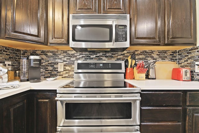 kitchen featuring stainless steel appliances, tasteful backsplash, and dark brown cabinetry