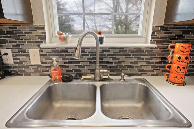 interior details featuring tasteful backsplash and sink