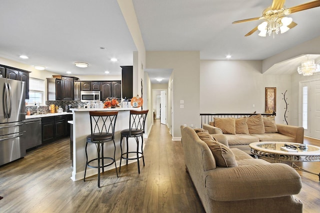 living room with hardwood / wood-style flooring and sink