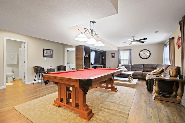 playroom featuring ceiling fan, billiards, light hardwood / wood-style floors, and a textured ceiling