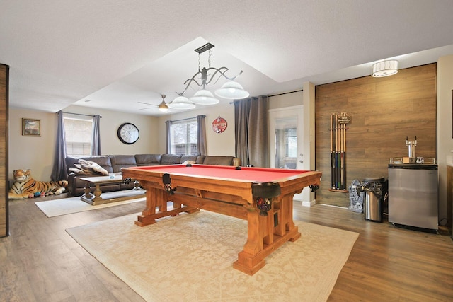 recreation room with hardwood / wood-style flooring, pool table, ceiling fan, and wood walls