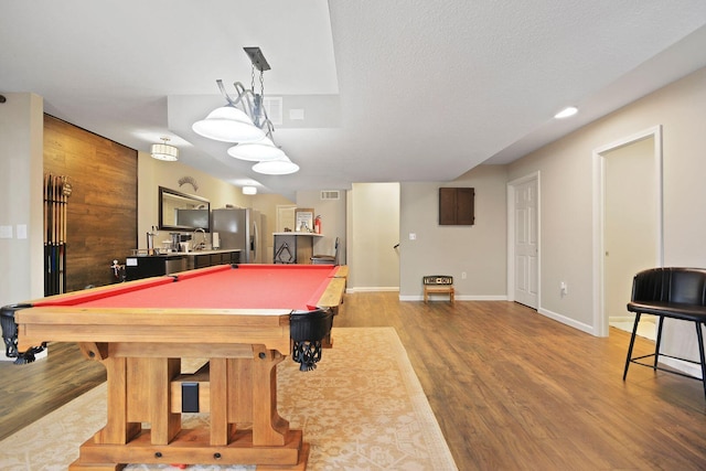 rec room with hardwood / wood-style flooring, pool table, and a textured ceiling