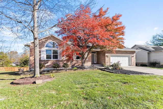 view of property hidden behind natural elements with a garage and a front lawn