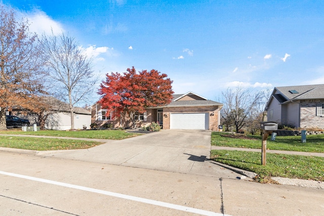 view of front of home with a garage and a front lawn