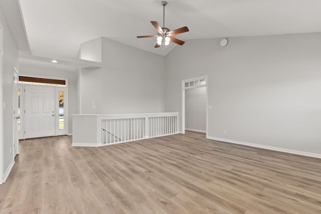 spare room with ceiling fan, high vaulted ceiling, and light hardwood / wood-style flooring