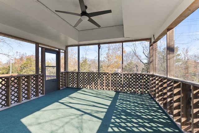 unfurnished sunroom featuring ceiling fan