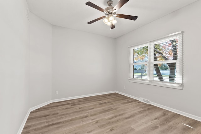 spare room with hardwood / wood-style floors and ceiling fan