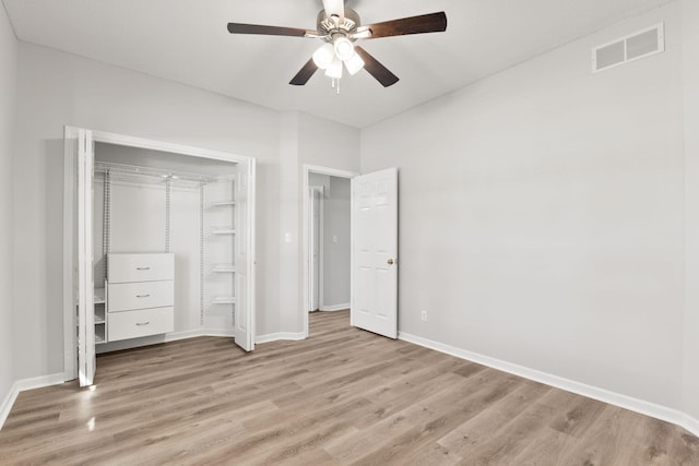 unfurnished bedroom with ceiling fan, light wood-type flooring, and a closet