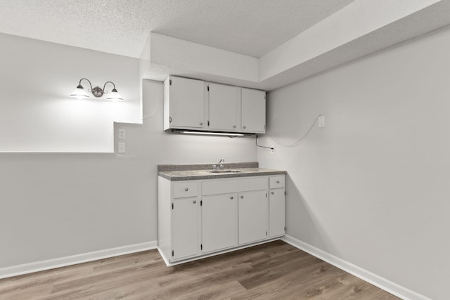 kitchen with a textured ceiling and hardwood / wood-style flooring