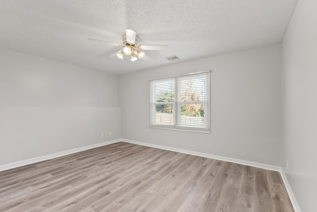 unfurnished room with ceiling fan, light hardwood / wood-style floors, and a textured ceiling