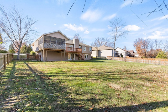 view of yard featuring a wooden deck and a sunroom