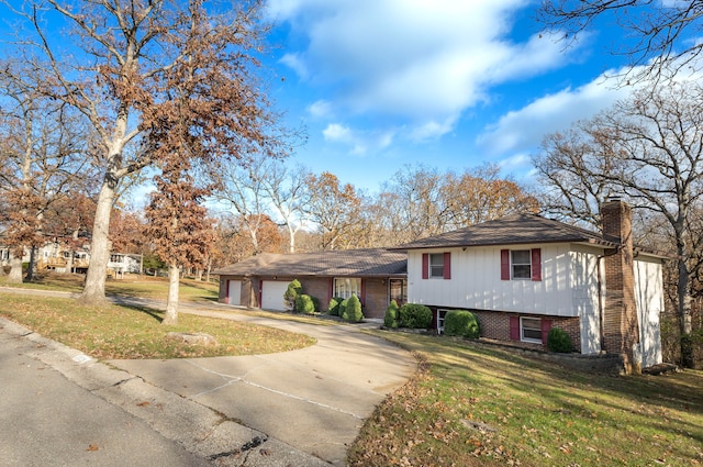 split level home with a front yard and a garage