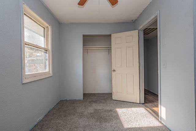 unfurnished bedroom featuring ceiling fan, a closet, and carpet floors