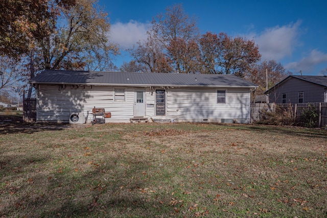 back of property with a lawn