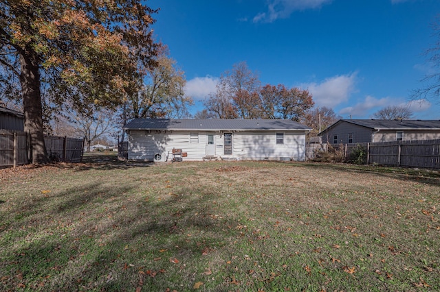 back of house with a yard