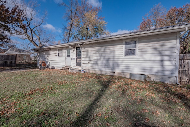 rear view of house featuring a lawn