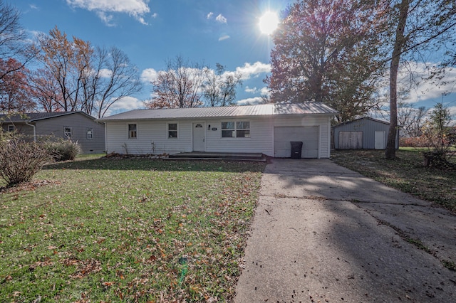 rear view of property with an outdoor structure and a lawn