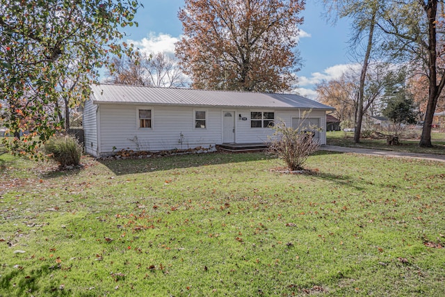 rear view of house featuring a yard