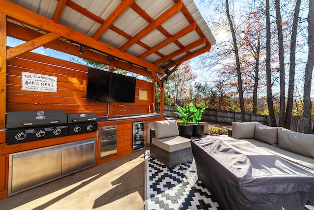 view of patio / terrace featuring area for grilling, an outdoor living space, wine cooler, and a grill