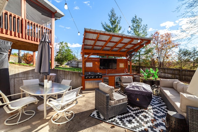 view of patio featuring an outdoor kitchen, area for grilling, an outdoor living space, beverage cooler, and sink