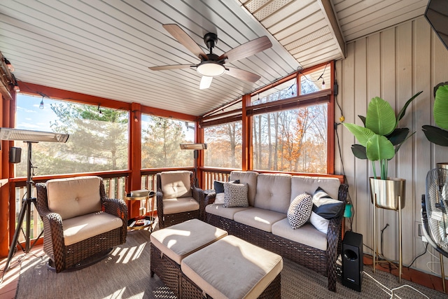 sunroom / solarium with lofted ceiling, wooden ceiling, ceiling fan, and a healthy amount of sunlight