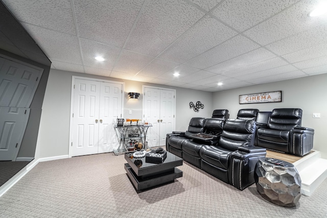 home theater featuring carpet flooring and a paneled ceiling