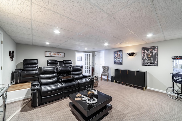 cinema room featuring a drop ceiling and carpet