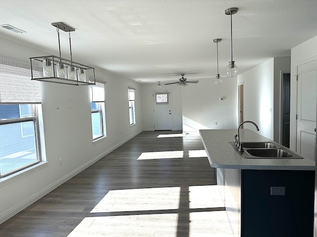 kitchen featuring decorative light fixtures, plenty of natural light, and sink