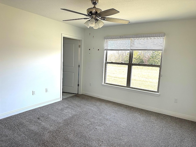 spare room featuring ceiling fan, carpet floors, and a textured ceiling