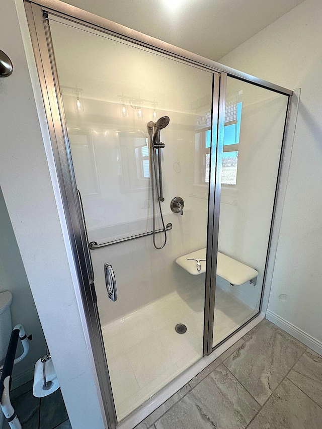 bathroom with a shower with door