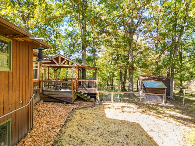 view of yard with a shed and a deck