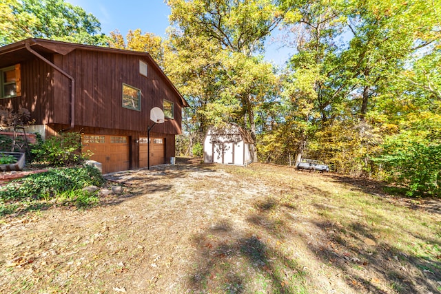 view of property exterior featuring a shed and a garage