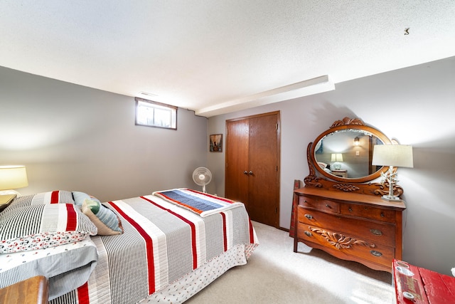 bedroom with a textured ceiling and light carpet