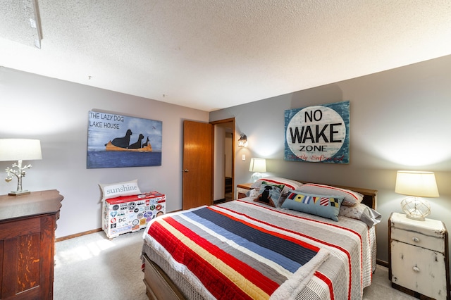 bedroom with a textured ceiling and light colored carpet