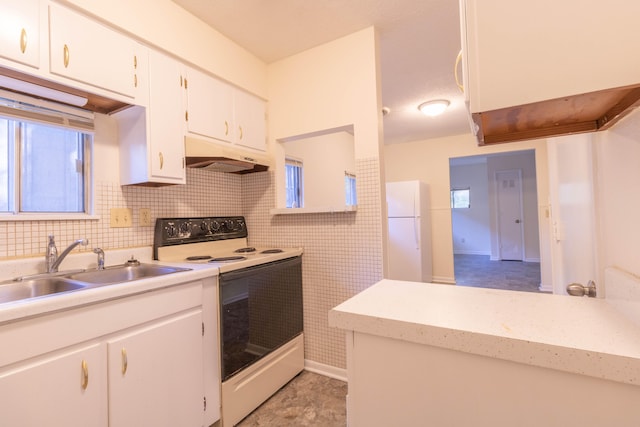 kitchen with white appliances, white cabinetry, and sink