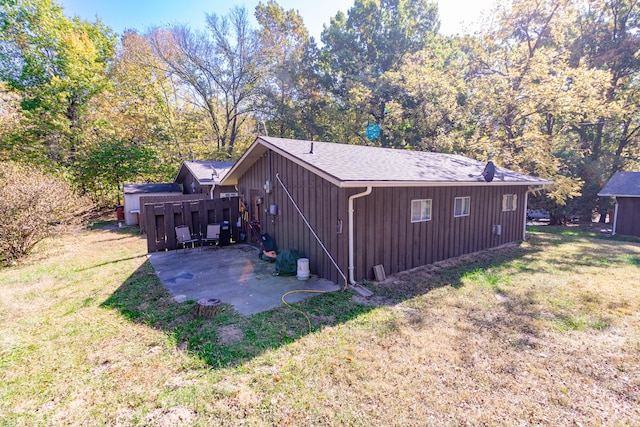 view of property exterior featuring a patio and a lawn