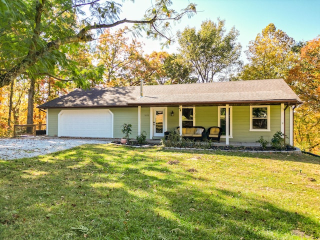 ranch-style home with a front lawn, covered porch, and a garage