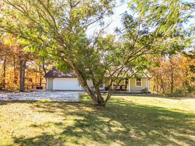 obstructed view of property with a front yard and a garage