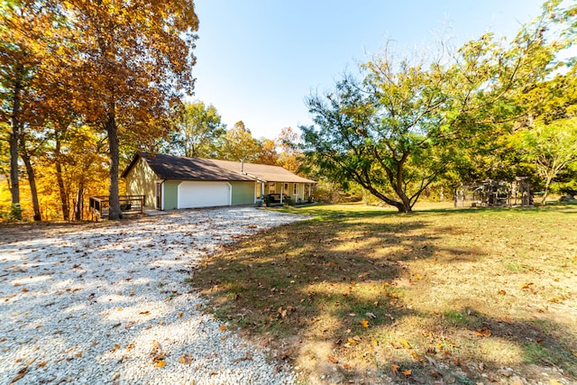 view of front of property featuring a front yard and a garage