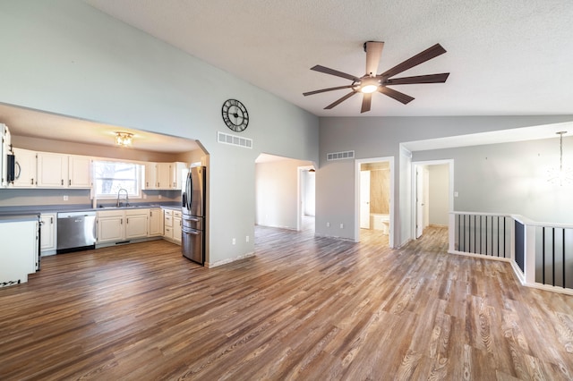 kitchen featuring stainless steel appliances, ceiling fan, sink, light hardwood / wood-style flooring, and white cabinets