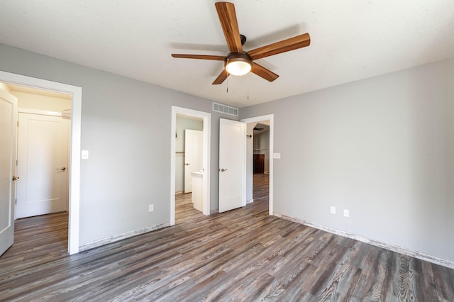 unfurnished bedroom featuring ceiling fan and dark hardwood / wood-style floors