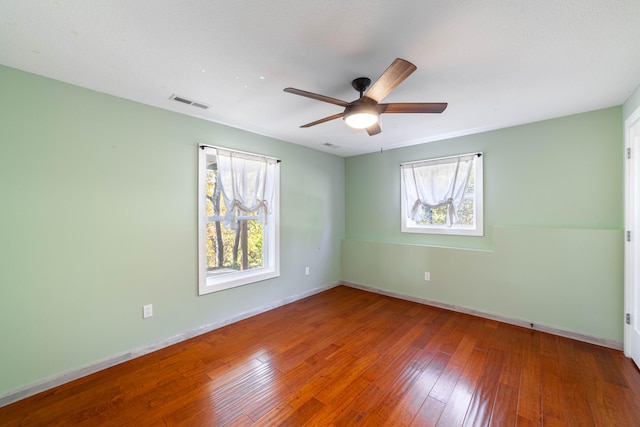 empty room featuring wood-type flooring and ceiling fan