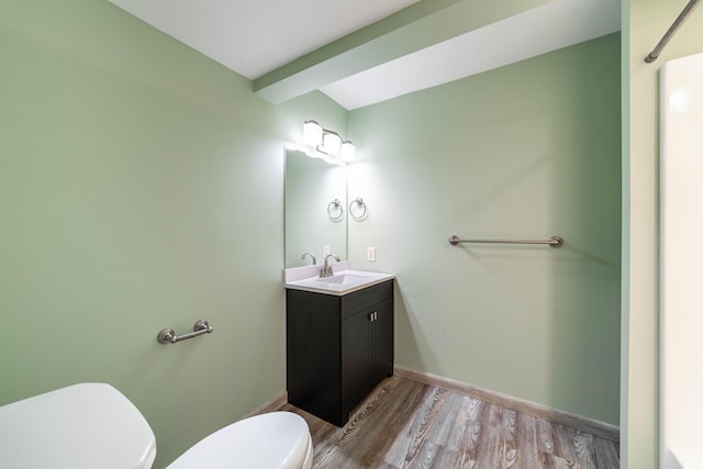 bathroom featuring hardwood / wood-style floors, vanity, and toilet