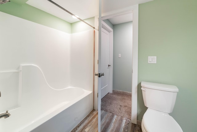 bathroom featuring hardwood / wood-style flooring and toilet