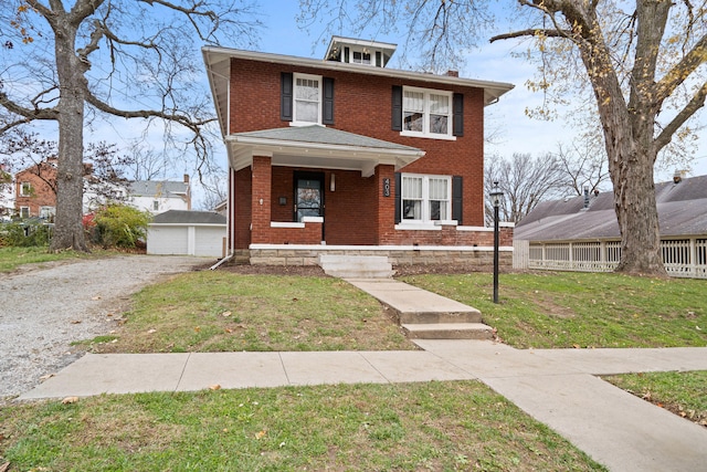 view of front of home featuring an outbuilding, a garage, and a front yard