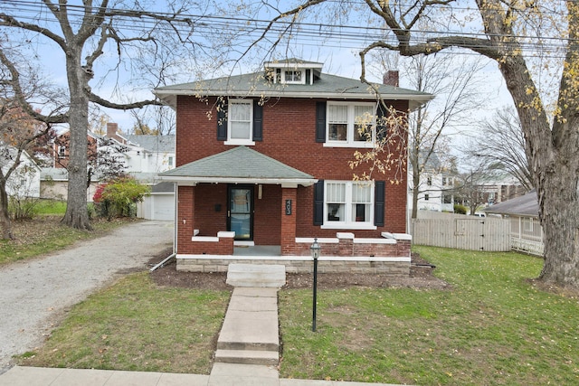 view of front of property with an outbuilding, a garage, and a front lawn